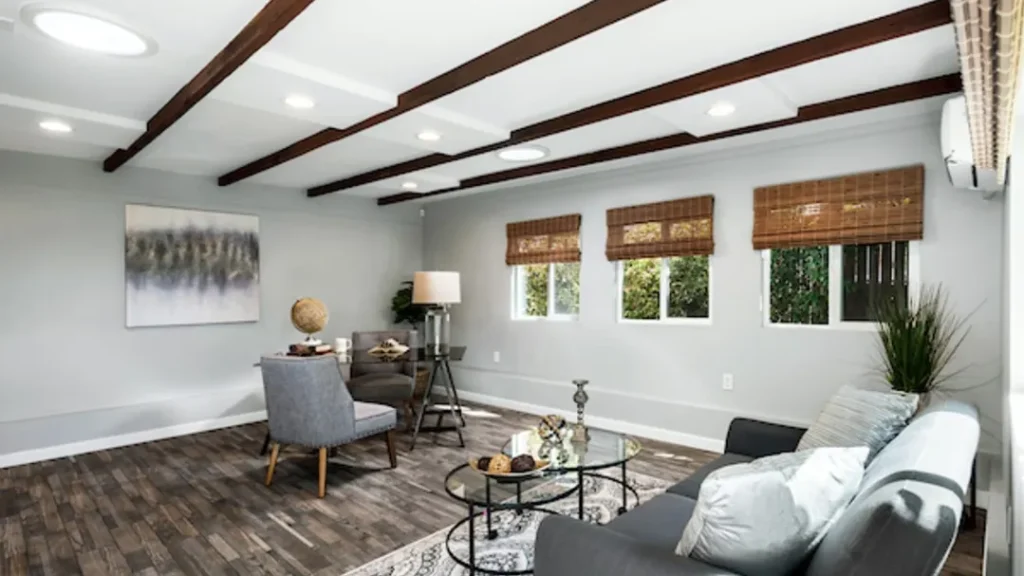 Living room with gray seating, round coffee tables and bamboo window shades